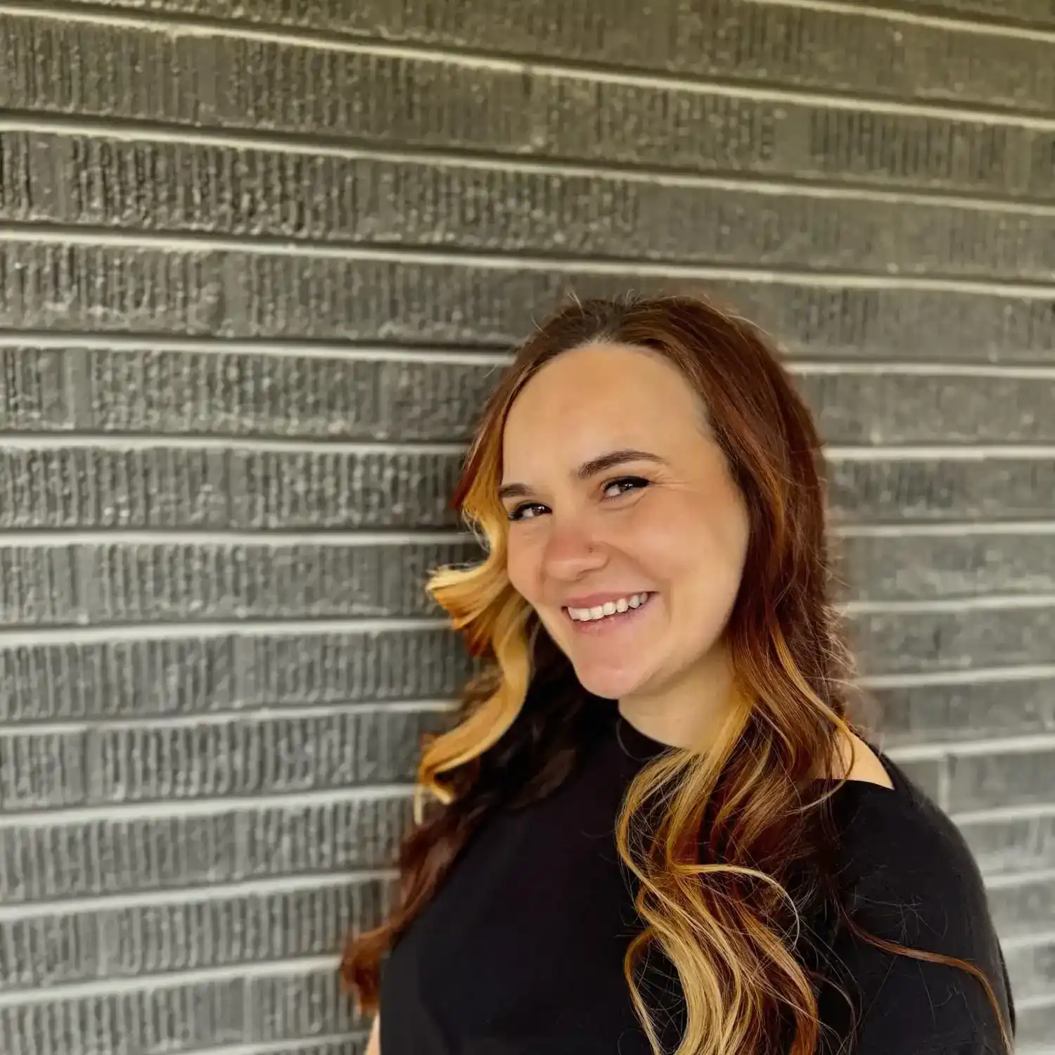 Portrait of Nadja, a professional stylist at Style Bar Salon, showcasing their expertise and style.
