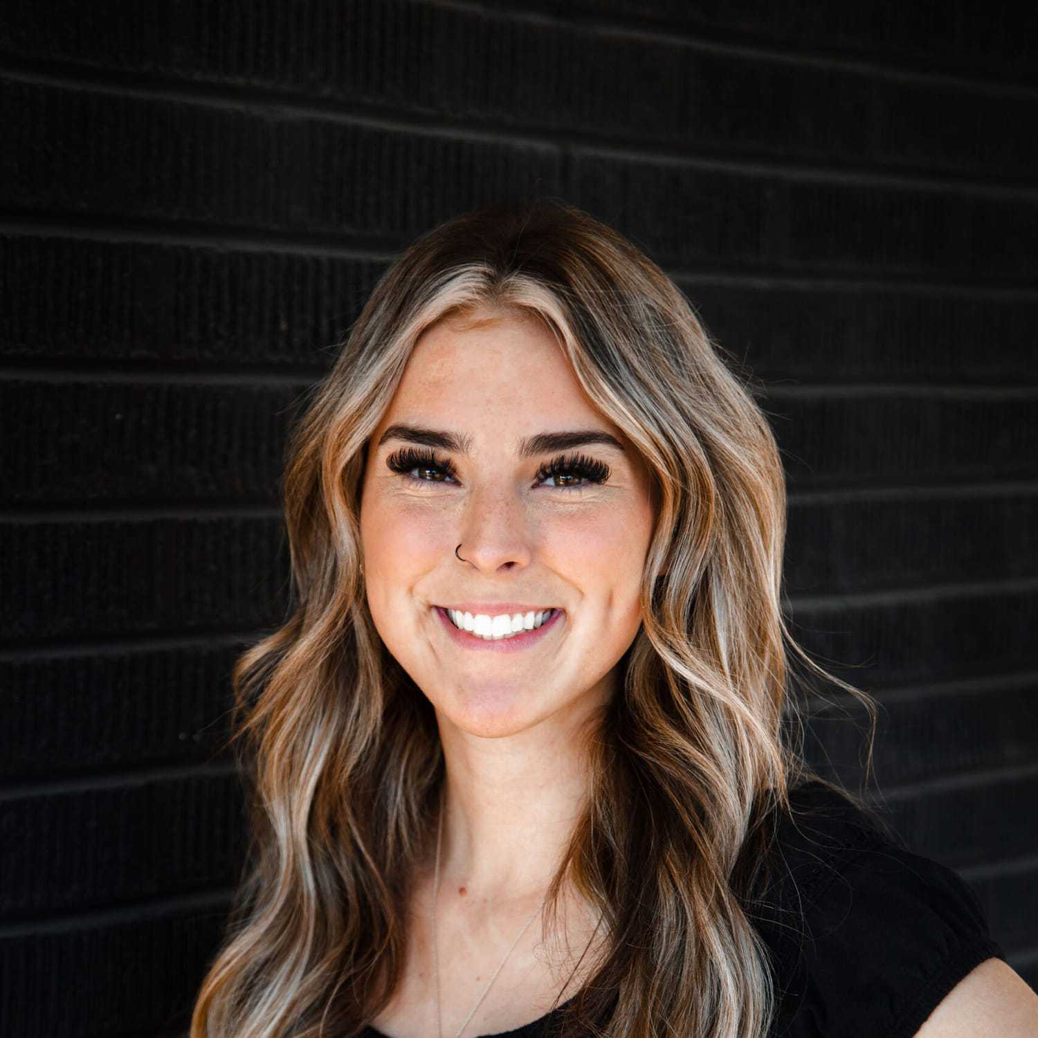 Portrait of Ali, a professional stylist at Style Bar Salon, showcasing their expertise and style.