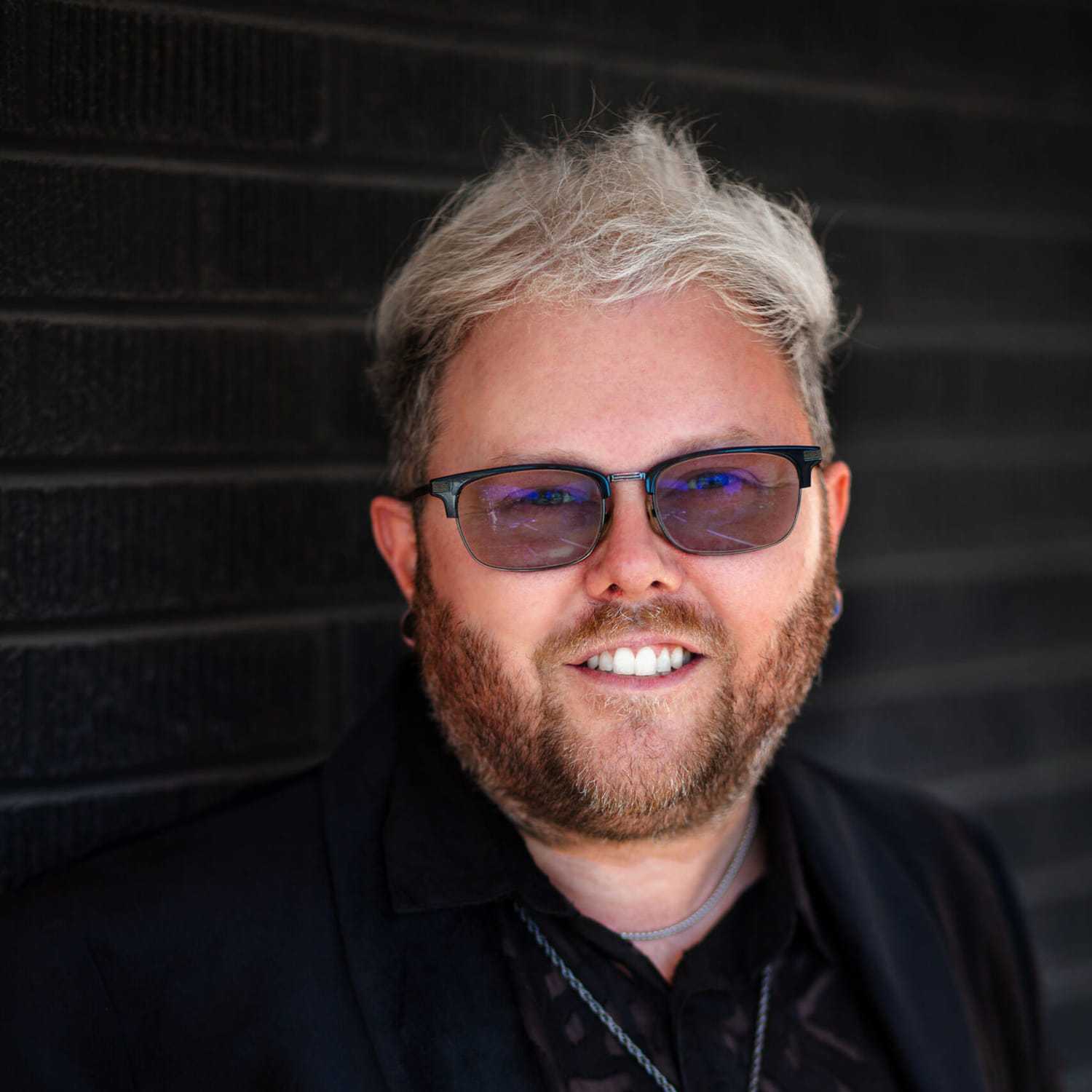 Portrait of Jarid Scheurer, a professional stylist at Style Bar Salon, showcasing their expertise and style.
