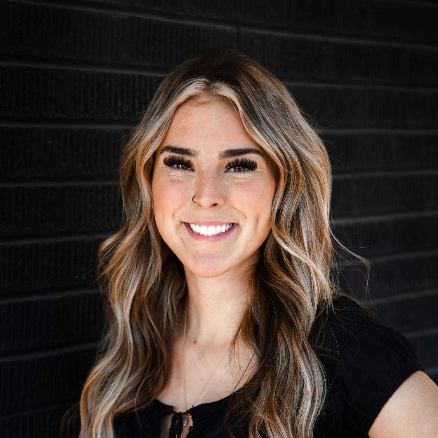 Portrait of Ali, a professional stylist at Style Bar Salon, showcasing their expertise and style.