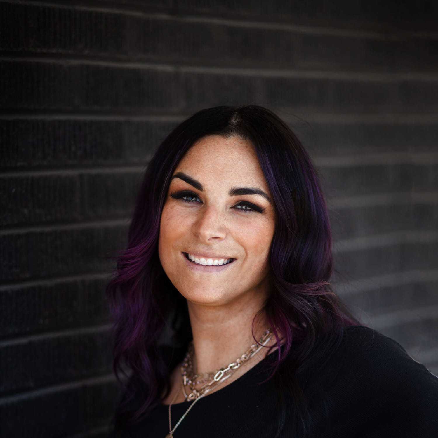 Portrait of Magi Gordon, a professional stylist at Style Bar Salon, showcasing their expertise and style.