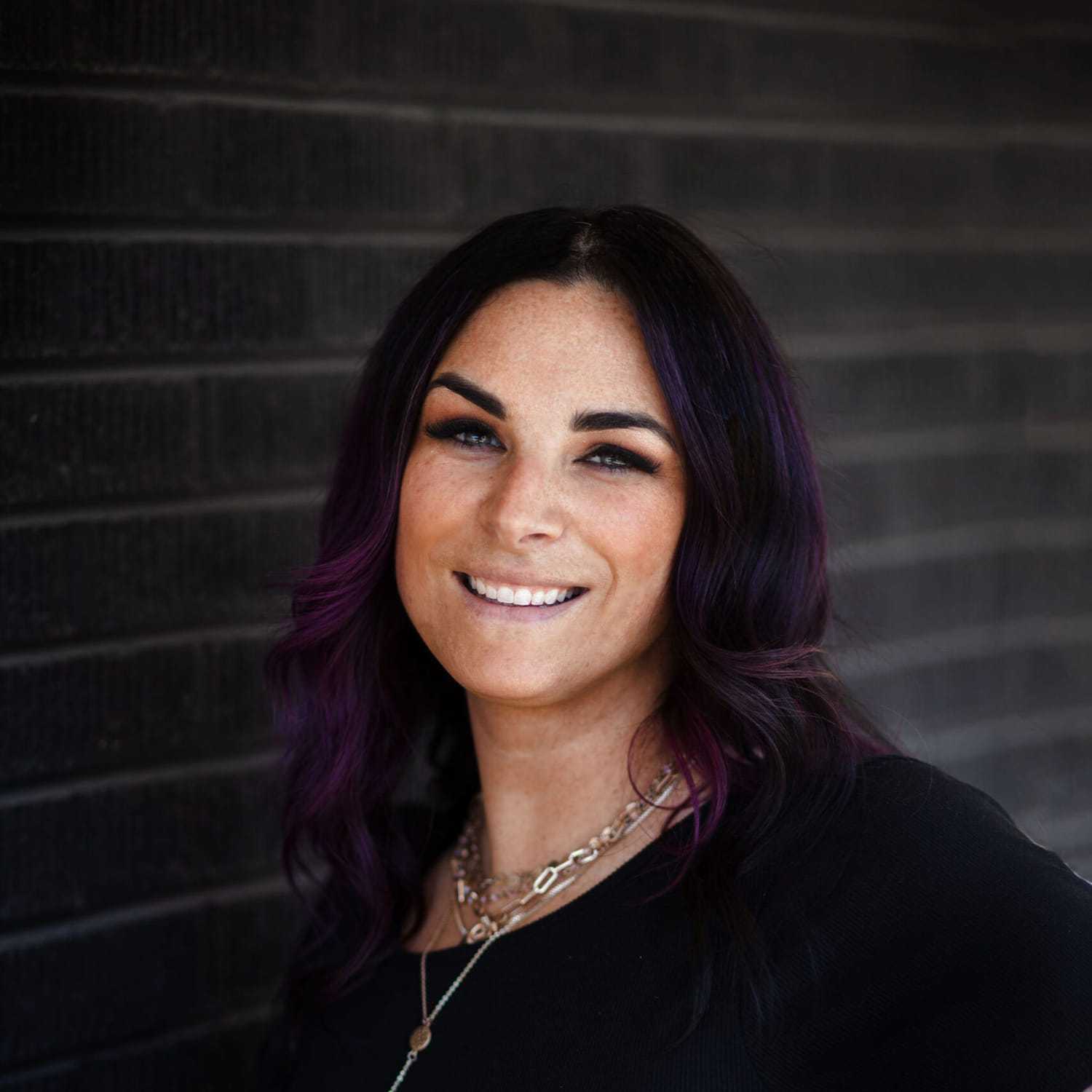 Portrait of Magi Gordon, a professional stylist at Style Bar Salon, showcasing their expertise and style.