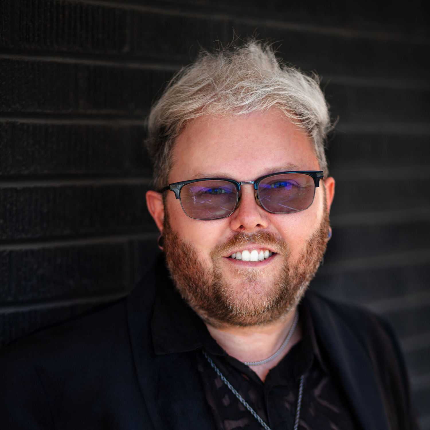 Portrait of Jarid Scheurer, a professional stylist at Style Bar Salon, showcasing their expertise and style.